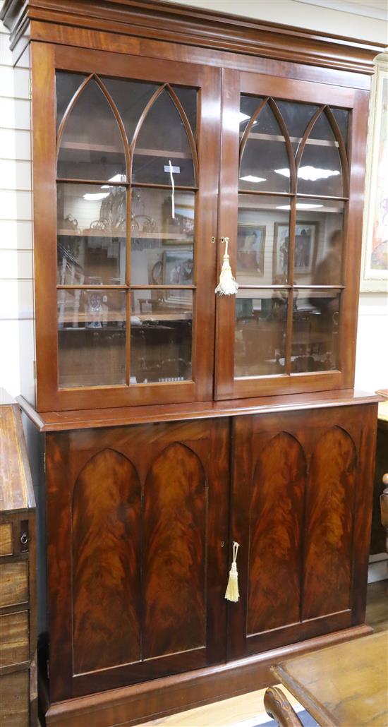 A Victorian mahogany library bookcase, the base fitted with an arrangement of twenty two drawers over a concealed plinth drawer W.126cm